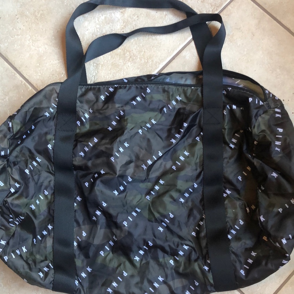 Dark green and black camo duffle bag